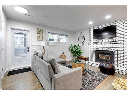 104 Mckerrell Crescent Se, Calgary, AB - Indoor Photo Showing Living Room With Fireplace