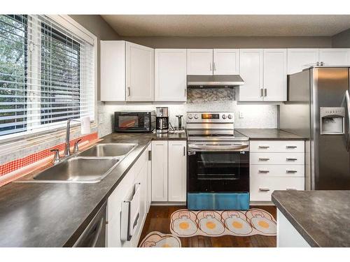 127 Covepark Place Ne, Calgary, AB - Indoor Photo Showing Kitchen With Double Sink