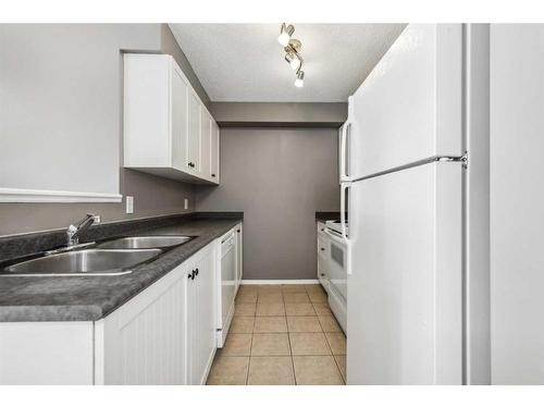 1228-2371 Eversyde Avenue Sw, Calgary, AB - Indoor Photo Showing Kitchen With Double Sink