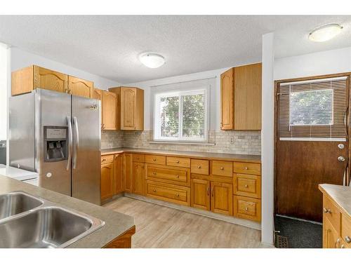 79 Lake Sylvan Close Se, Calgary, AB - Indoor Photo Showing Kitchen With Double Sink