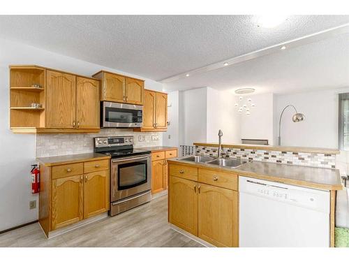 79 Lake Sylvan Close Se, Calgary, AB - Indoor Photo Showing Kitchen With Double Sink