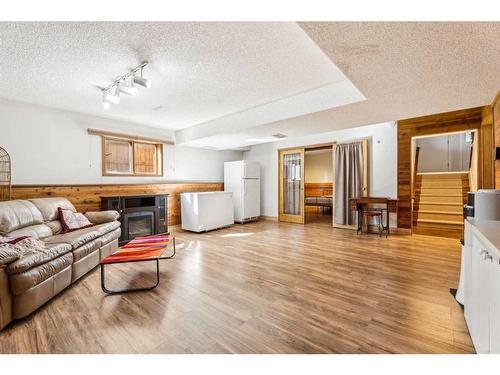 120 Tucker Road Se, Airdrie, AB - Indoor Photo Showing Living Room With Fireplace