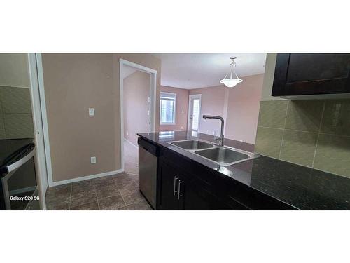 2310-81 Legacy Boulevard Se, Calgary, AB - Indoor Photo Showing Kitchen With Double Sink