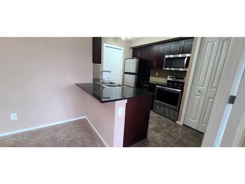 2310-81 Legacy Boulevard Se, Calgary, AB - Indoor Photo Showing Kitchen With Double Sink