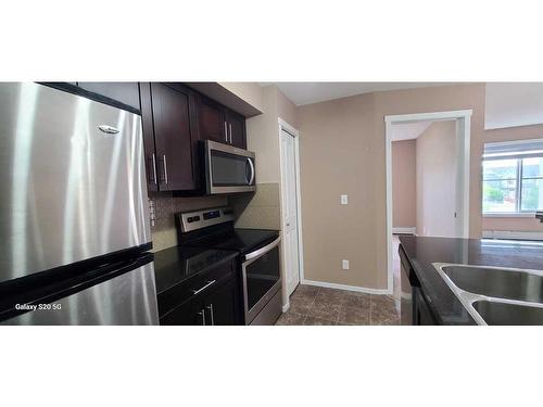 2310-81 Legacy Boulevard Se, Calgary, AB - Indoor Photo Showing Kitchen With Double Sink