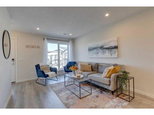 211-260 Rowley Way Nw, Calgary, AB - Indoor Photo Showing Living Room