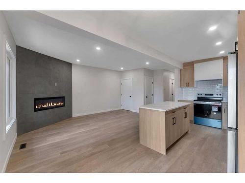 1327B 35 Street Se, Calgary, AB - Indoor Photo Showing Kitchen With Fireplace