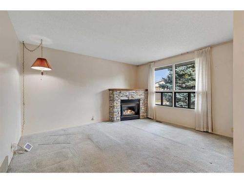 6355 Ranchview Drive Nw, Calgary, AB - Indoor Photo Showing Living Room With Fireplace