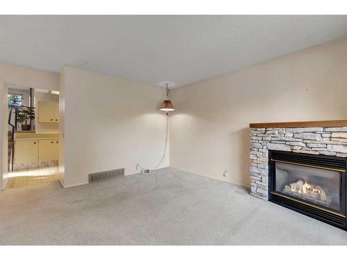 6355 Ranchview Drive Nw, Calgary, AB - Indoor Photo Showing Living Room With Fireplace