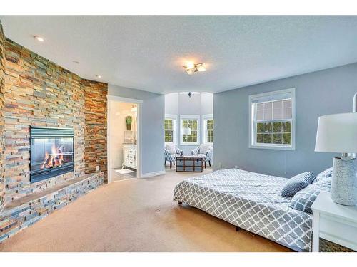 31055 Elbow River Drive, Rural Rocky View County, AB - Indoor Photo Showing Bedroom With Fireplace