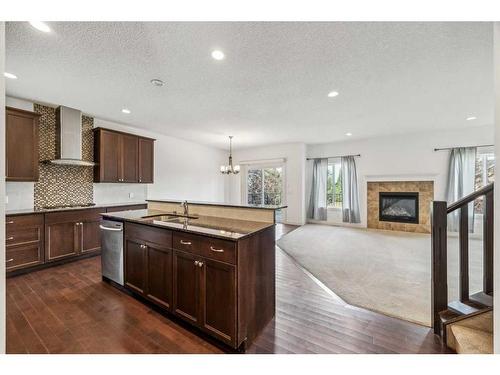 102 Cranarch Common Se, Calgary, AB - Indoor Photo Showing Kitchen With Fireplace