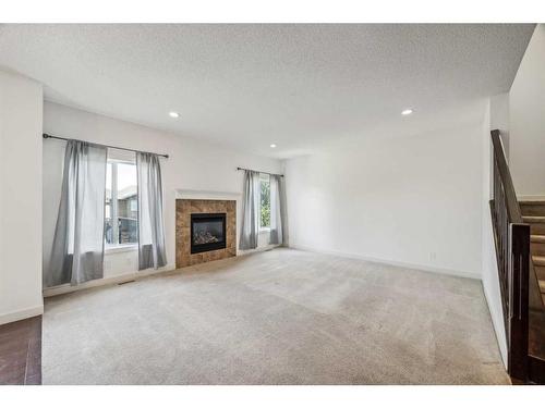 102 Cranarch Common Se, Calgary, AB - Indoor Photo Showing Living Room With Fireplace