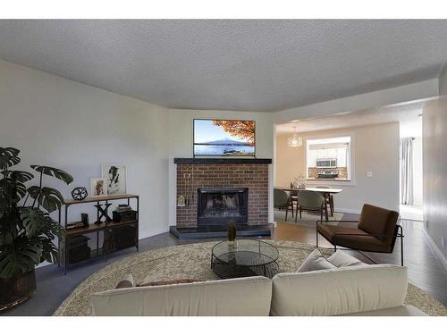 243 Berwick Drive Nw, Calgary, AB - Indoor Photo Showing Living Room With Fireplace