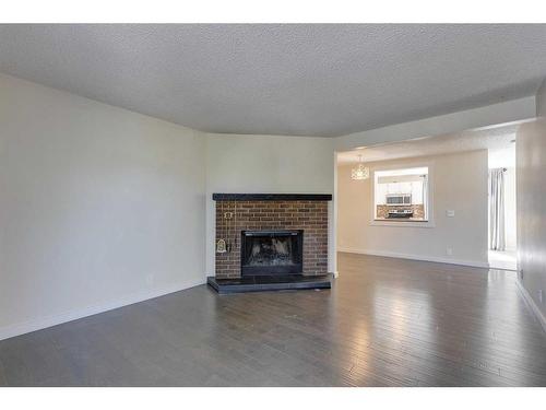 243 Berwick Drive Nw, Calgary, AB - Indoor Photo Showing Living Room With Fireplace