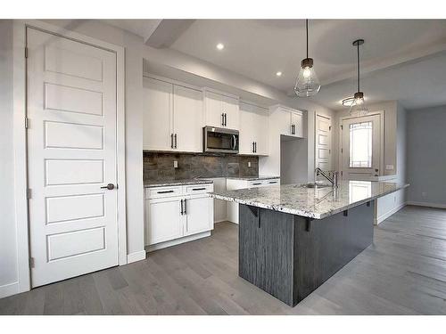 56 Shale Avenue, Cochrane, AB - Indoor Photo Showing Kitchen With Upgraded Kitchen