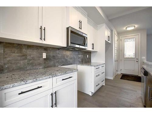 56 Shale Avenue, Cochrane, AB - Indoor Photo Showing Kitchen With Upgraded Kitchen