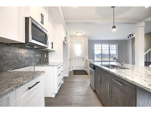 56 Shale Avenue, Cochrane, AB - Indoor Photo Showing Kitchen With Double Sink With Upgraded Kitchen