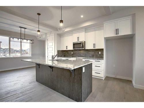 56 Shale Avenue, Cochrane, AB - Indoor Photo Showing Kitchen With Upgraded Kitchen