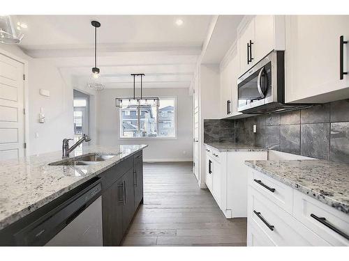 56 Shale Avenue, Cochrane, AB - Indoor Photo Showing Kitchen With Double Sink With Upgraded Kitchen