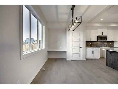 56 Shale Avenue, Cochrane, AB - Indoor Photo Showing Kitchen With Upgraded Kitchen