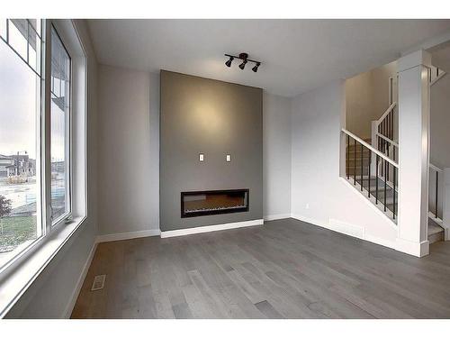 56 Shale Avenue, Cochrane, AB - Indoor Photo Showing Living Room With Fireplace