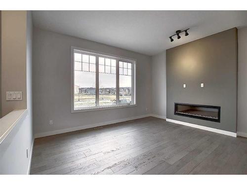 56 Shale Avenue, Cochrane, AB - Indoor Photo Showing Other Room With Fireplace