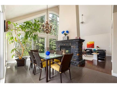 8 Spring Willow Place Sw, Calgary, AB - Indoor Photo Showing Dining Room With Fireplace