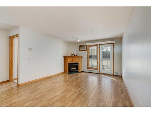 126-6868 Sierra Morena Boulevard Sw, Calgary, AB - Indoor Photo Showing Living Room With Fireplace