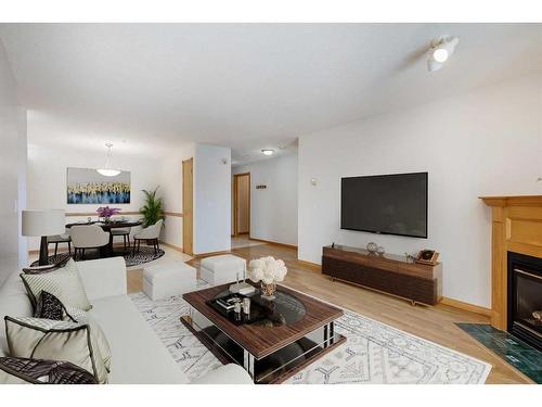 126-6868 Sierra Morena Boulevard Sw, Calgary, AB - Indoor Photo Showing Living Room With Fireplace