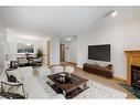 126-6868 Sierra Morena Boulevard Sw, Calgary, AB  - Indoor Photo Showing Living Room With Fireplace 