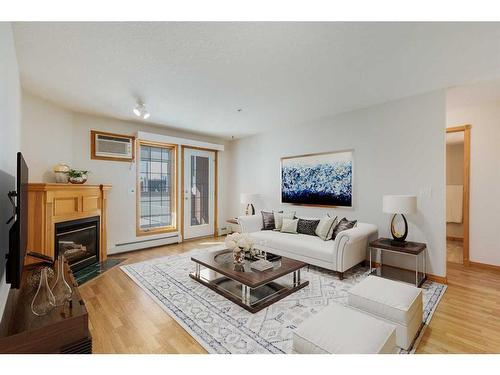 126-6868 Sierra Morena Boulevard Sw, Calgary, AB - Indoor Photo Showing Living Room With Fireplace