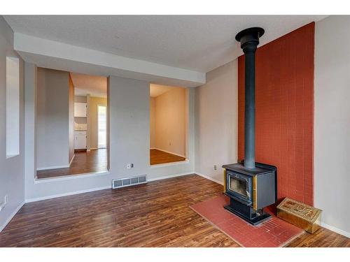 703-120 Silvercreek Close Nw, Calgary, AB - Indoor Photo Showing Other Room With Fireplace