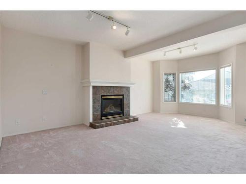 61 Scimitar Heath Nw, Calgary, AB - Indoor Photo Showing Living Room With Fireplace