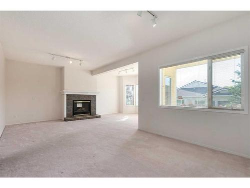 61 Scimitar Heath Nw, Calgary, AB - Indoor Photo Showing Other Room With Fireplace