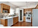 61 Scimitar Heath Nw, Calgary, AB  - Indoor Photo Showing Kitchen With Double Sink 