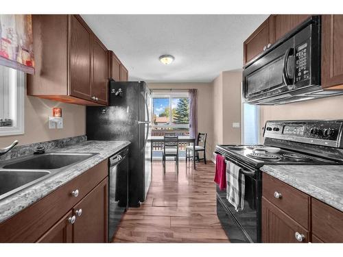 9 Mckenna Crescent Se, Calgary, AB - Indoor Photo Showing Kitchen With Double Sink