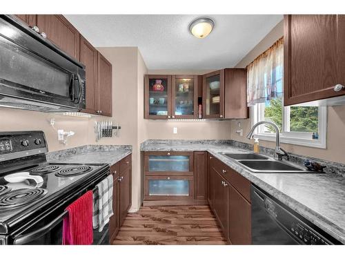 9 Mckenna Crescent Se, Calgary, AB - Indoor Photo Showing Kitchen With Double Sink