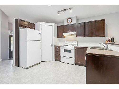 64 Prestwick Villas Se, Calgary, AB - Indoor Photo Showing Kitchen With Double Sink