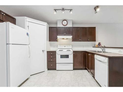 64 Prestwick Villas Se, Calgary, AB - Indoor Photo Showing Kitchen With Double Sink