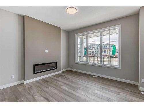 256 Waterford Heath, Chestermere, AB - Indoor Photo Showing Living Room With Fireplace