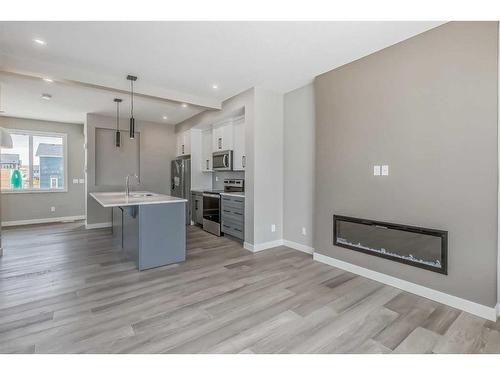 256 Waterford Heath, Chestermere, AB - Indoor With Fireplace