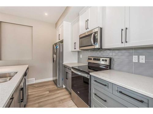 256 Waterford Heath, Chestermere, AB - Indoor Photo Showing Kitchen With Double Sink With Upgraded Kitchen