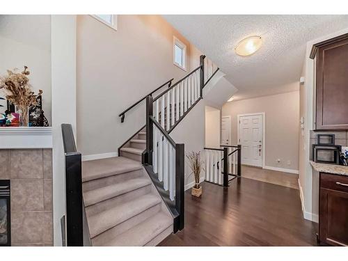 97 Panton Way Nw, Calgary, AB - Indoor Photo Showing Other Room With Fireplace