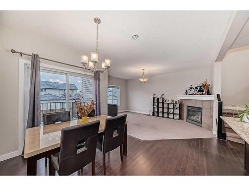 97 Panton Way Nw, Calgary, AB - Indoor Photo Showing Dining Room With Fireplace