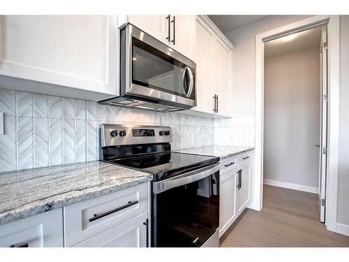 99 Waterford Manor, Chestermere, AB - Indoor Photo Showing Kitchen With Upgraded Kitchen