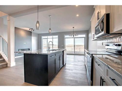 99 Waterford Manor, Chestermere, AB - Indoor Photo Showing Kitchen With Upgraded Kitchen