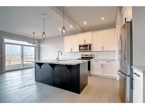 99 Waterford Manor, Chestermere, AB - Indoor Photo Showing Kitchen With Upgraded Kitchen