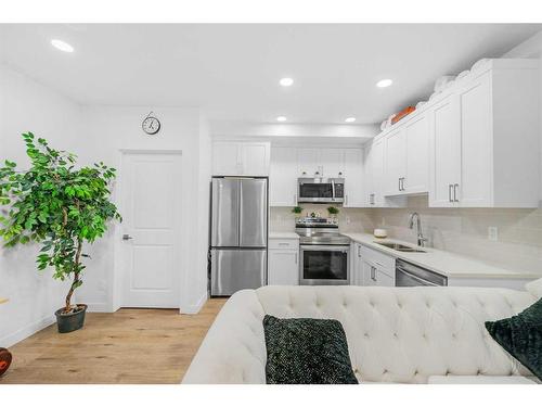 15 Walcrest Row Se, Calgary, AB - Indoor Photo Showing Kitchen With Stainless Steel Kitchen With Double Sink