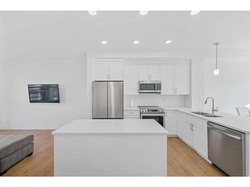 15 Walcrest Row Se, Calgary, AB - Indoor Photo Showing Kitchen With Stainless Steel Kitchen With Double Sink With Upgraded Kitchen