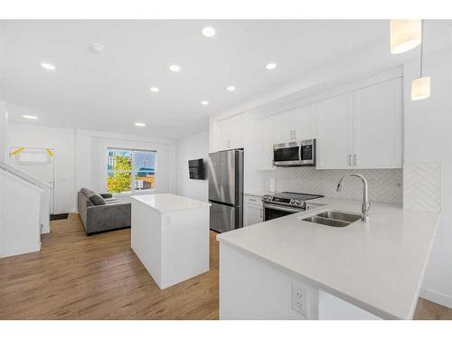 15 Walcrest Row Se, Calgary, AB - Indoor Photo Showing Kitchen With Stainless Steel Kitchen With Double Sink With Upgraded Kitchen